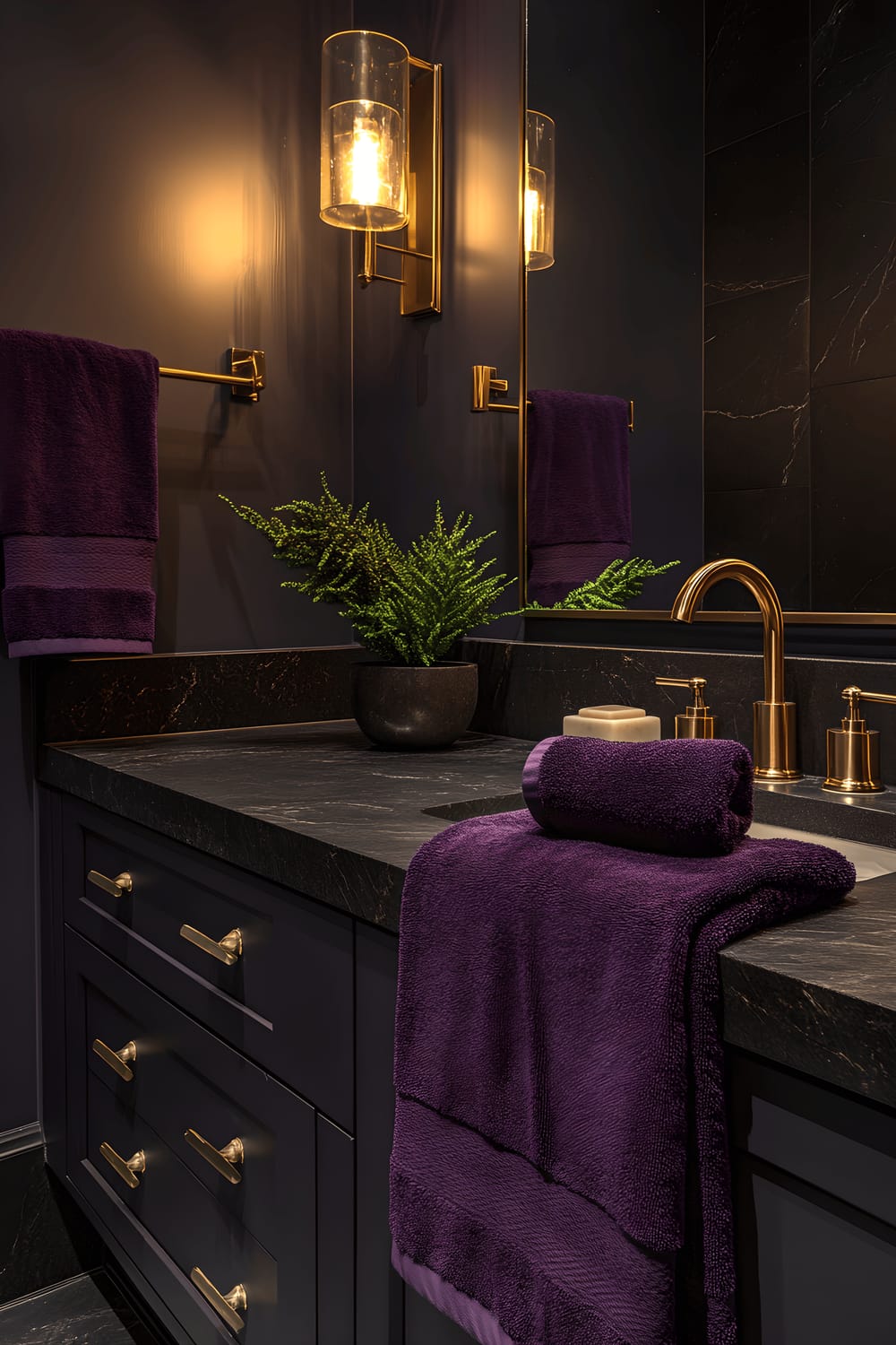 A sophisticated bathroom with the primary theme of plum color, featuring porcelain fixtures and a matte black marble countertop. Objects in the bathroom include Royal purple satin towels arranged neatly on a charcoal gray vanity, gold leafed brass lighting fixtures providing a warm glow, and a standalone emerald green plant adding a touch of nature to the serene environment.