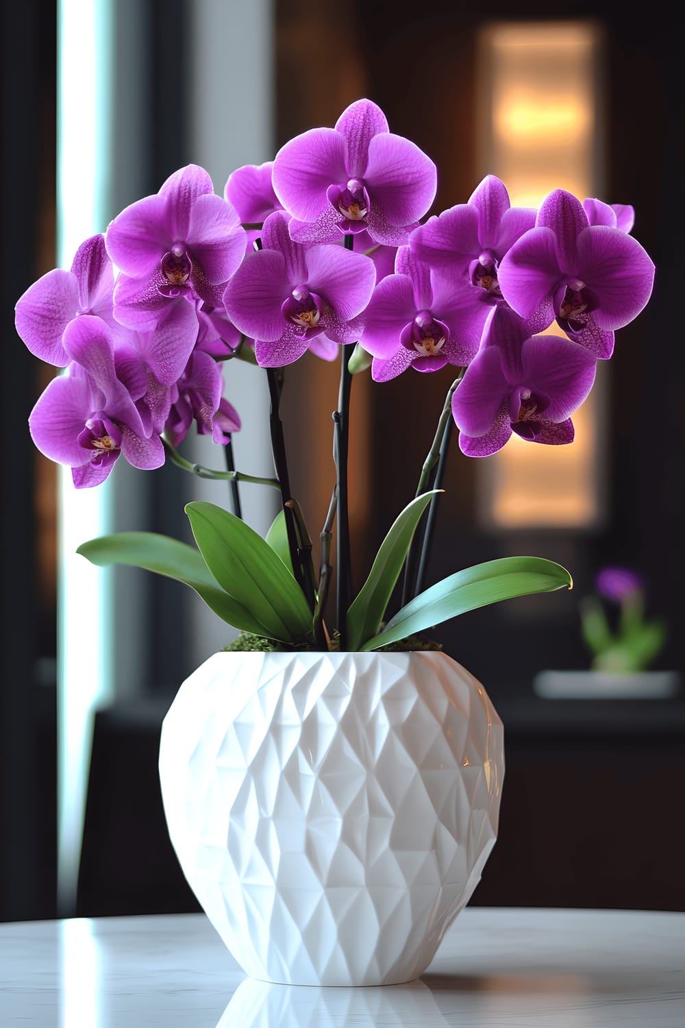 The image shows a dining room with dark wooden furniture and a large window that lets in soft ambient light. There's a centerpiece on the dining table which features a minimalist white porcelain vase with geometric patterns. Inside the vase are three large, vivid purple orchids, along with a subtle hint of green bamboo leaves. This arrangement stands out against the muted tones of the room.