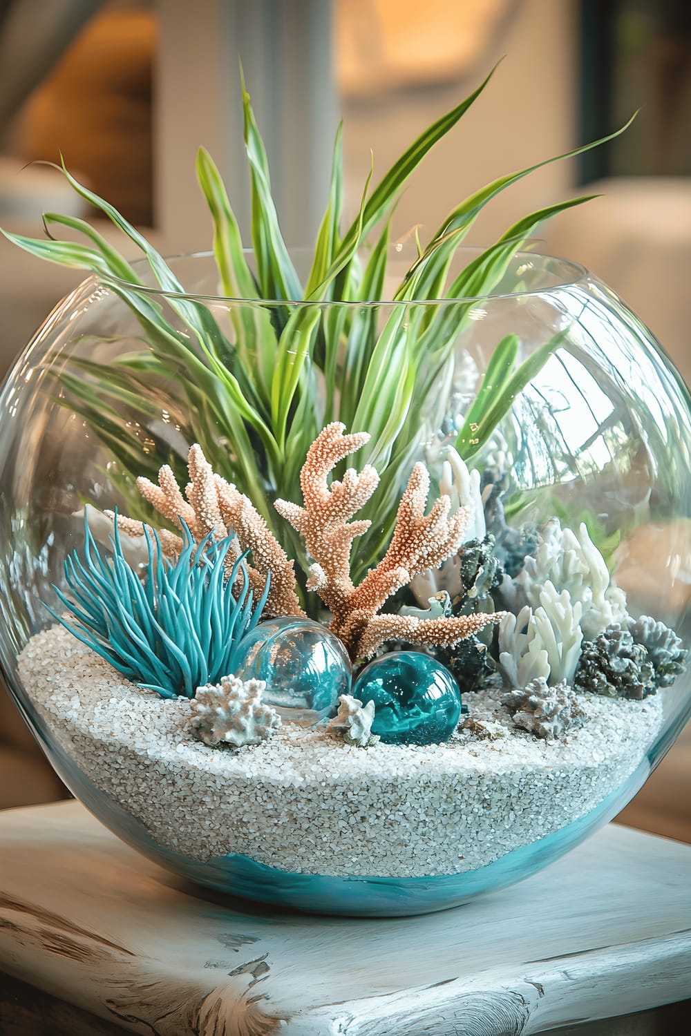 A charming terrarium filled with silver sand, coral fragments, and teal glass figurines in marine shapes, surrounded by live air plants. The terrarium is placed on a light-hued driftwood table, and the radiant silver sand contrasts beautifully with the vibrant coral and teal. Light pouring in enhances the oceanic aura of the setup, alluding to a breezy beach house atmosphere.