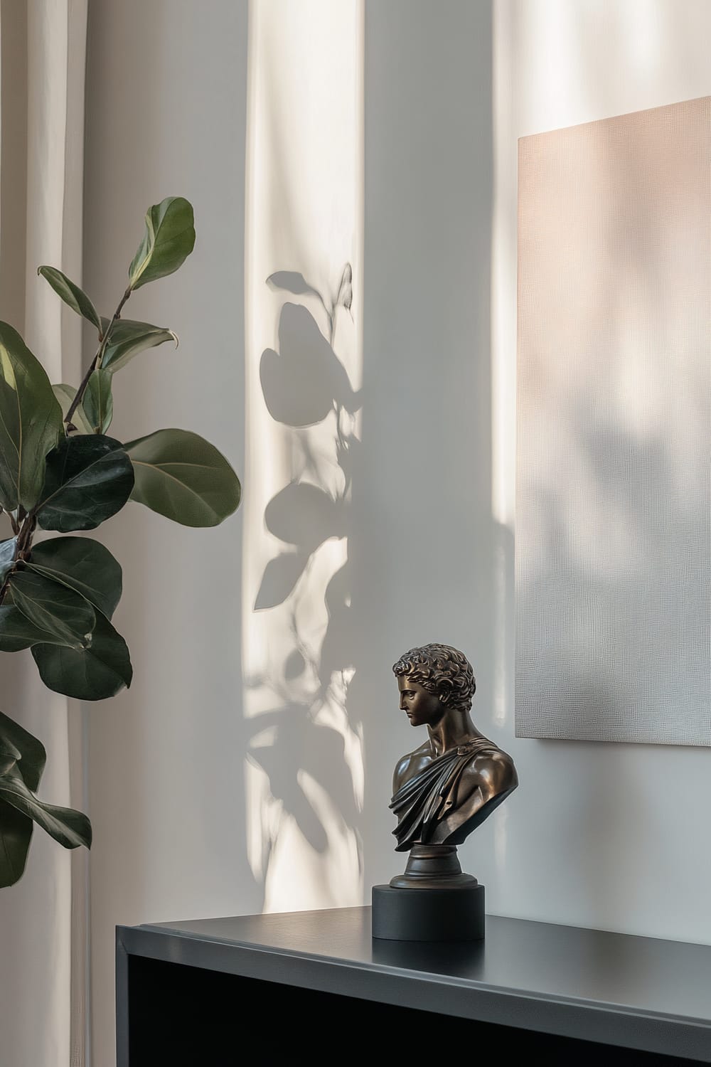 A bronze figurine of Apollo on a black shelf against a white wall with an abstract painting and a green plant.