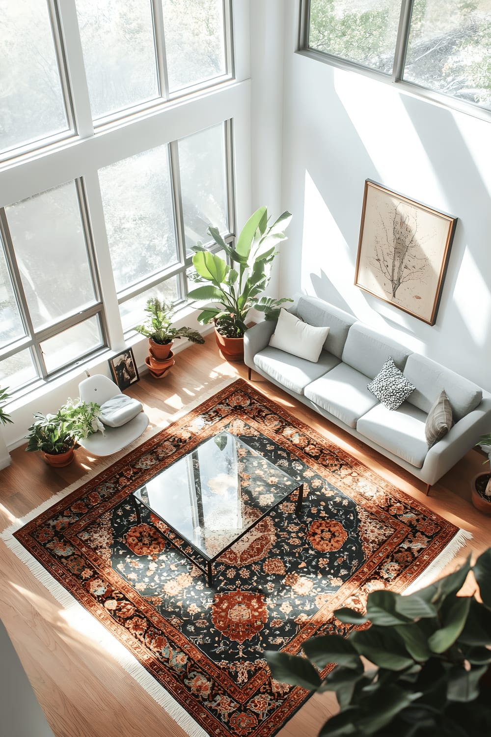 An airy minimalist living room featuring white walls, large windows, a sleek glass coffee table, a minimalist gray sofa, and a vibrant Persian rug with intricate patterns. A green Snake Plant adds a touch of nature to the room. Bright sunlight shines from the windows, highlighting the rich details of the Persian rug.