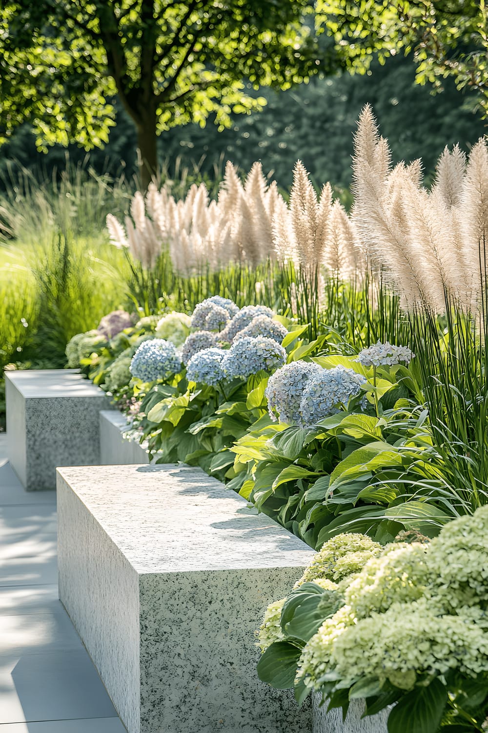 A lush garden with a multilayered arrangement of plants of varying heights and colors, including low green and blue hostas, mid-height white and pink hydrangeas, and tall pampas grass. Punctuating the scene are minimalist stone benches and sleek metal planters, bathed in soft natural light filtering through overhead trees.