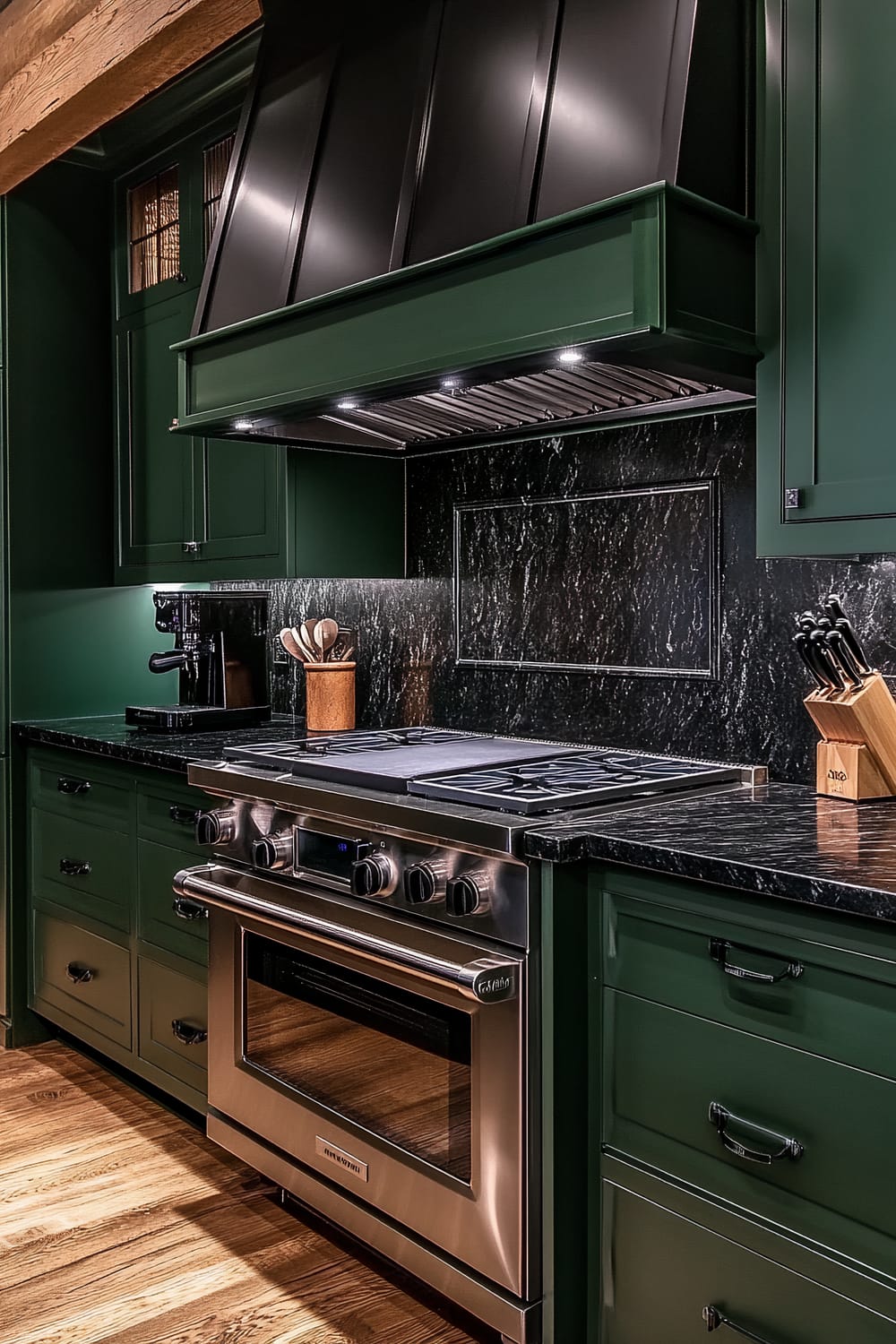 A moody farmhouse kitchen with deep forest green cabinets and ebony granite countertops. A matte black espresso machine is on the countertop, next to a gas range with a black minimalist hood. The backsplash features textured dark marble tiles. Subdued pendant lighting creates warm tones and soft shadows. Wooden accents, such as a knife block and utensil holder, are present.