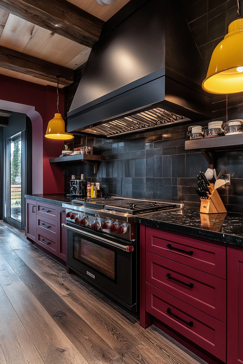 A top-down perspective of a moody farmhouse kitchen featuring rich burgundy cabinets, glossy black granite countertops, bright yellow pendant lights, dark wooden floors, a Café espresso maker, a gas range with a unique hood design, and a dishwasher hidden behind open shelving.