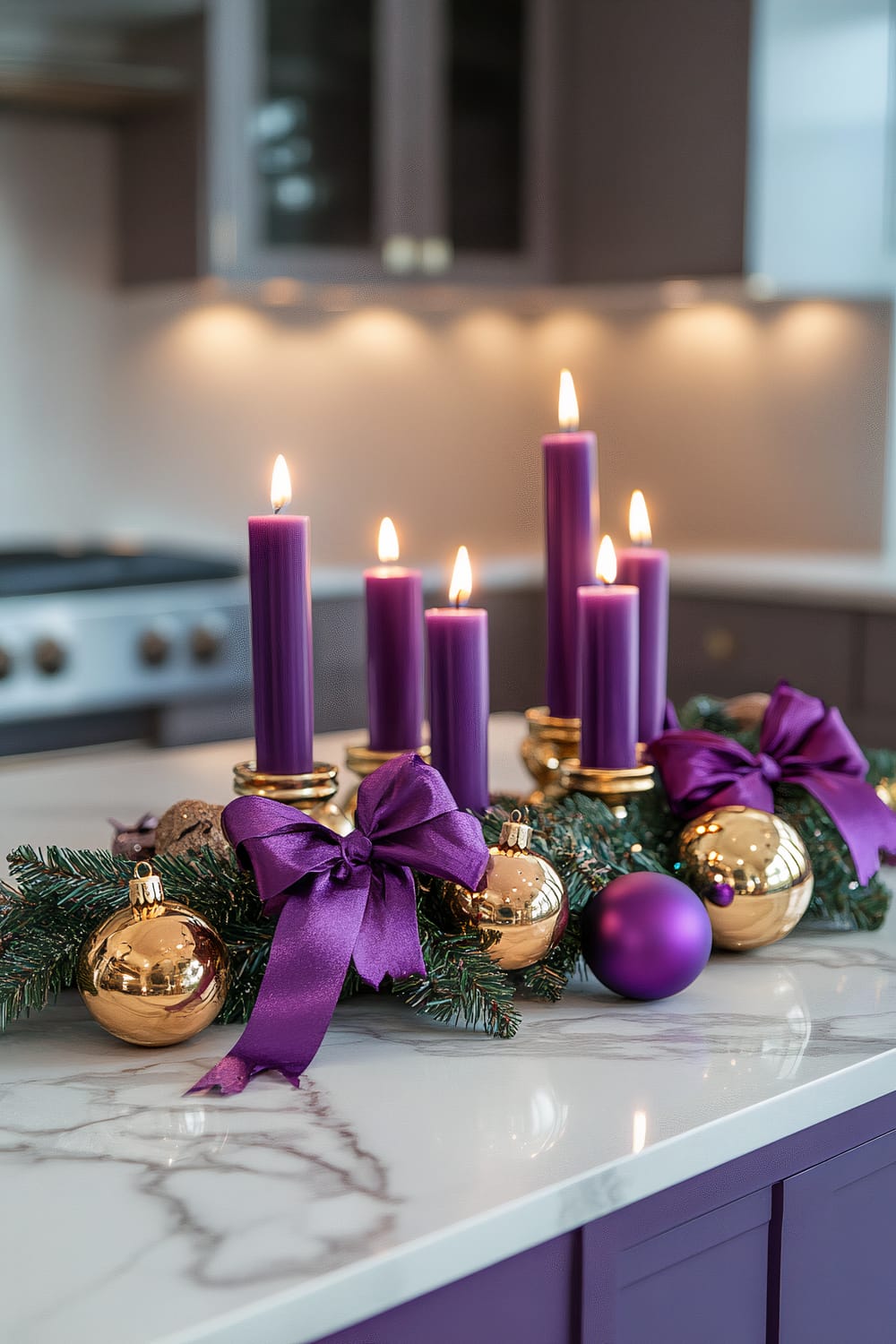 A contemporary kitchen decorated with a purple and gold Christmas theme. Five purple candles in gold holders are arranged on a marble countertop. The arrangement includes gold ornaments, elegant purple ribbons, and green sprigs, creating a festive centerpiece. Soft lighting enhances the luxurious color palette and casts dramatic shadows.