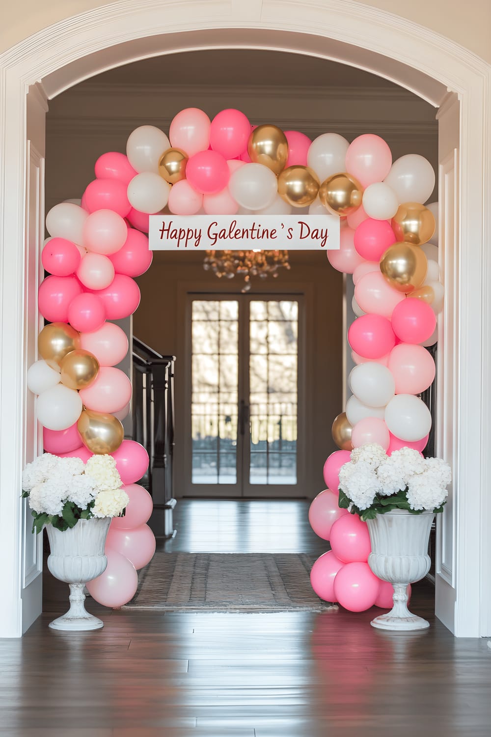 A picture of a charming entryway adorned with a vibrant arch made from pink, white, and gold balloons. The arch is topped with a "Happy Galentine’s Day" banner in elegant script lettering. Flanking the entrance are beautiful potted hydrangeas and white roses arranged in vintage ceramic planters. The scene is illuminated with soft natural light, creating a festive and welcoming ambiance.