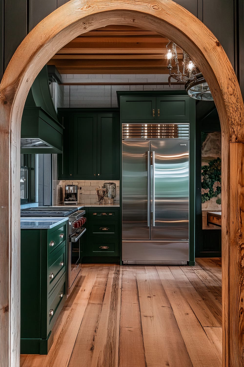 An atmospheric farmhouse kitchen viewed through a rustic wooden archway, featuring dark forest green cabinets, bright white marble countertops, and stainless steel appliances. The kitchen includes a double-door refrigerator, a professional-grade oven, and layered lighting such as overhead fixtures and under-cabinet lights. The space is accented with reclaimed wood beams and textured wallpaper, contributing to a moody ambiance.